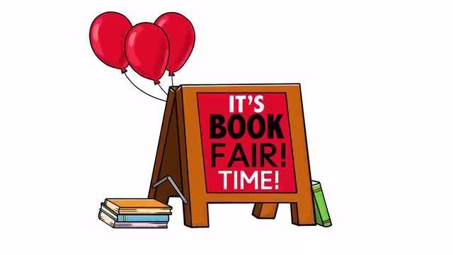 Easel with It's Book Fair Time on it with three red balloons and books stacked on the ground